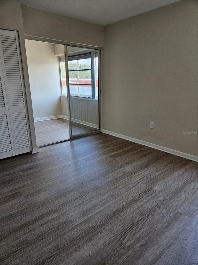 unfurnished bedroom with hardwood / wood-style flooring and a closet