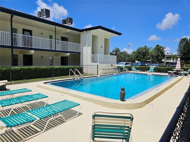 view of pool featuring central air condition unit