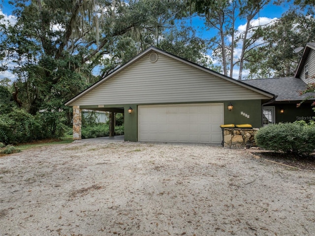 view of front of property featuring a shingled roof, an attached garage, and stucco siding