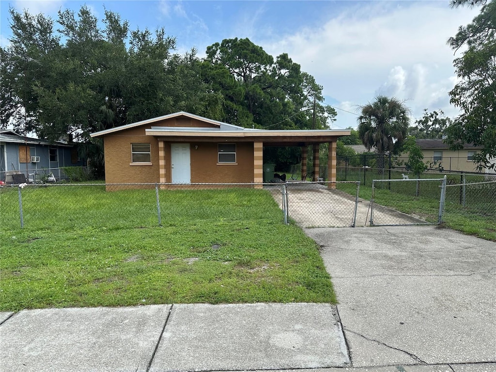 ranch-style house with a front yard and a carport