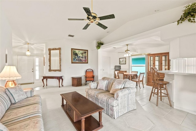 living room with ceiling fan, light tile patterned flooring, and vaulted ceiling