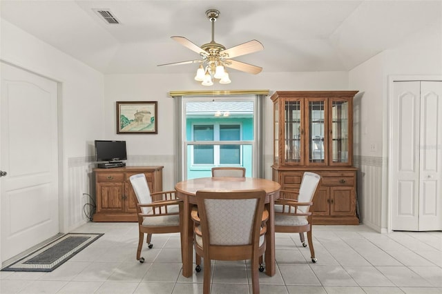 tiled dining space with ceiling fan