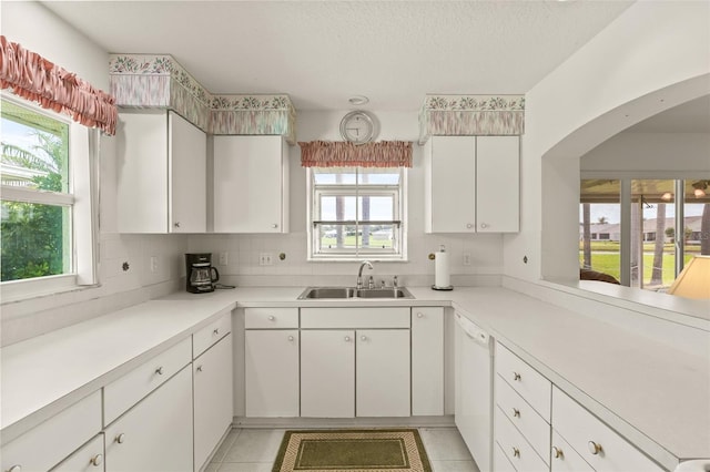 kitchen featuring light tile patterned flooring, sink, and a healthy amount of sunlight