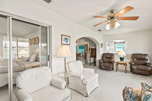 carpeted living room featuring ceiling fan