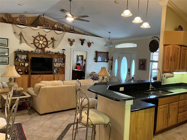 kitchen with crown molding, light tile patterned flooring, lofted ceiling, ceiling fan, and sink