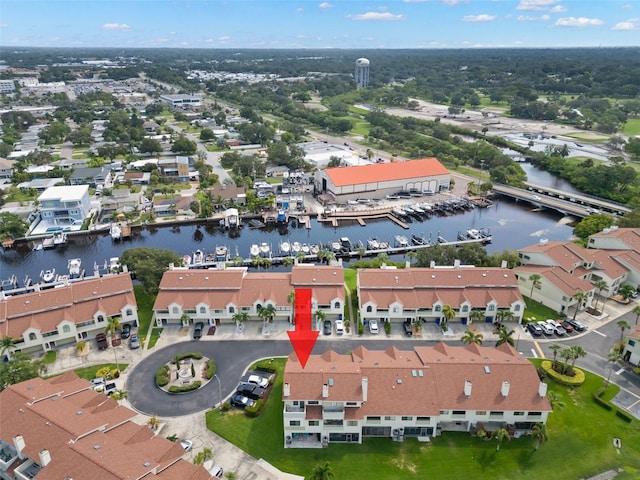 birds eye view of property with a water view and a residential view