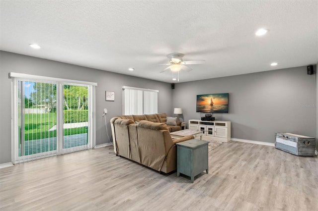 living area with recessed lighting, light wood-style flooring, ceiling fan, a textured ceiling, and baseboards