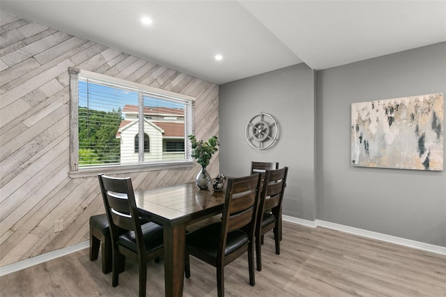 dining area featuring wooden walls, recessed lighting, light wood-style flooring, and baseboards