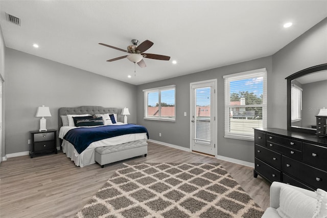 bedroom featuring access to outside, visible vents, light wood-style flooring, and baseboards