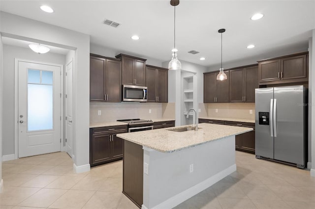 kitchen with visible vents, appliances with stainless steel finishes, a sink, and decorative light fixtures