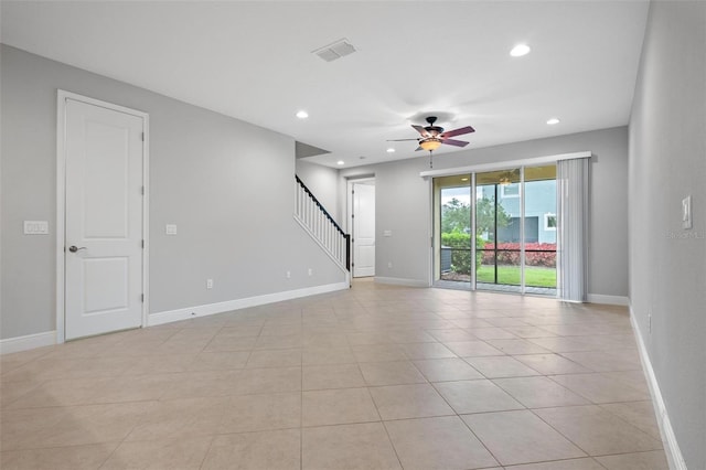 unfurnished room with stairway, recessed lighting, and baseboards