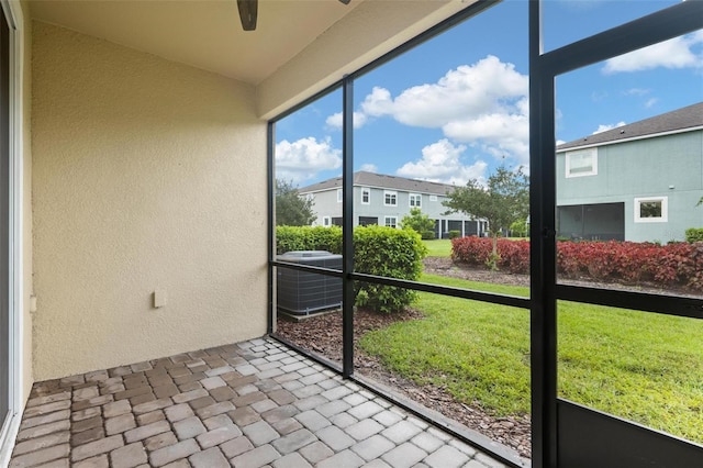 unfurnished sunroom with ceiling fan