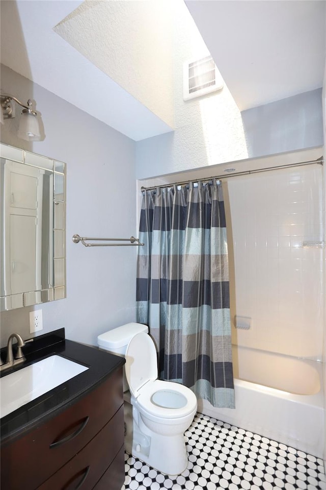 full bathroom featuring shower / bath combo, vanity, tile patterned flooring, and toilet