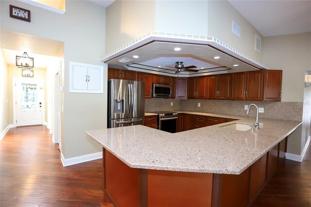 kitchen with decorative backsplash, ceiling fan, appliances with stainless steel finishes, dark wood-type flooring, and sink