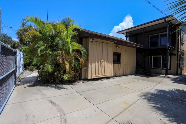 view of property exterior with a patio area