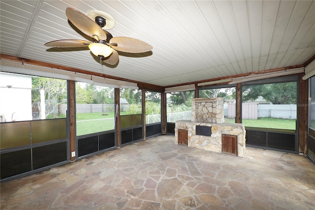 unfurnished sunroom featuring ceiling fan