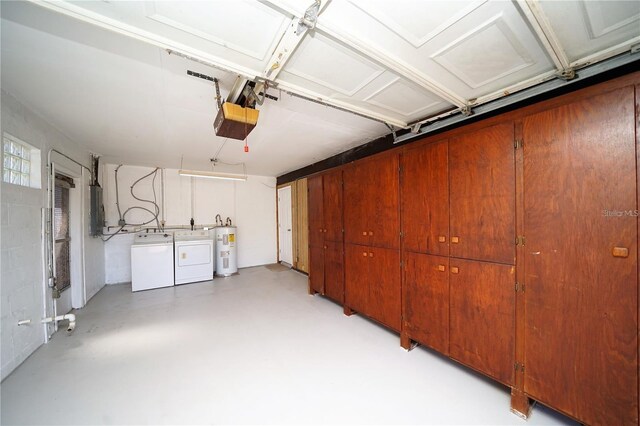 garage featuring a garage door opener, water heater, and washing machine and clothes dryer