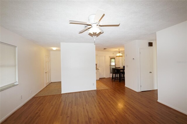 unfurnished room featuring ceiling fan, a textured ceiling, and hardwood / wood-style floors