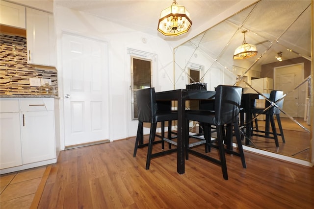 dining room with a chandelier and wood-type flooring