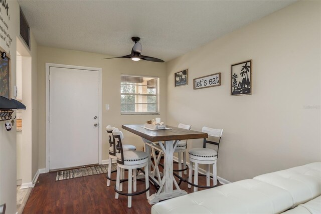 dining area with ceiling fan and hardwood / wood-style floors