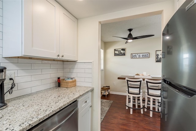 kitchen featuring dark hardwood / wood-style floors, dishwasher, ceiling fan, tasteful backsplash, and refrigerator