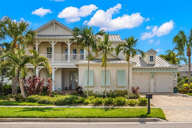 view of front facade with a balcony and a front yard