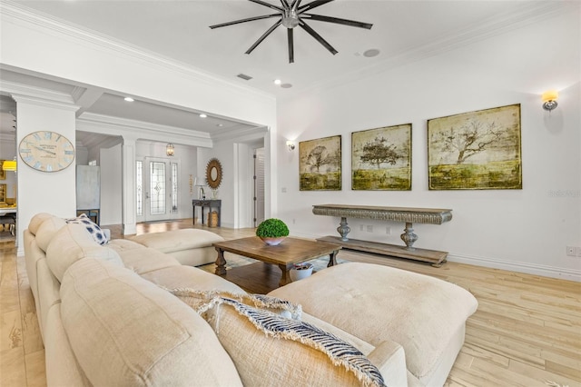 living room with ceiling fan, light hardwood / wood-style flooring, ornate columns, and ornamental molding