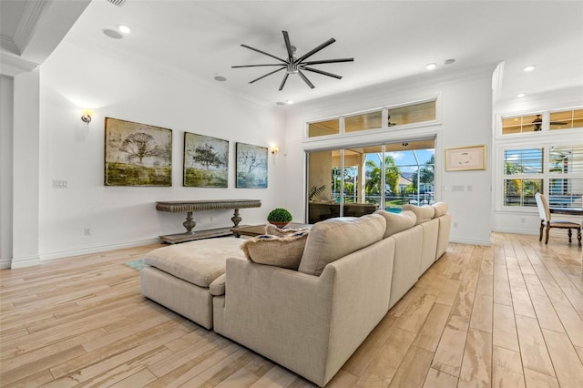 living room featuring ornamental molding and light hardwood / wood-style floors