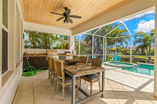 view of patio with glass enclosure, grilling area, a swimming pool with hot tub, ceiling fan, and exterior kitchen