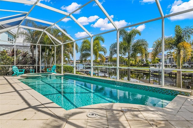 view of pool with glass enclosure, a water view, and an in ground hot tub