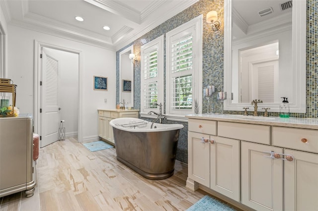 bathroom featuring vanity, a bathtub, and ornamental molding