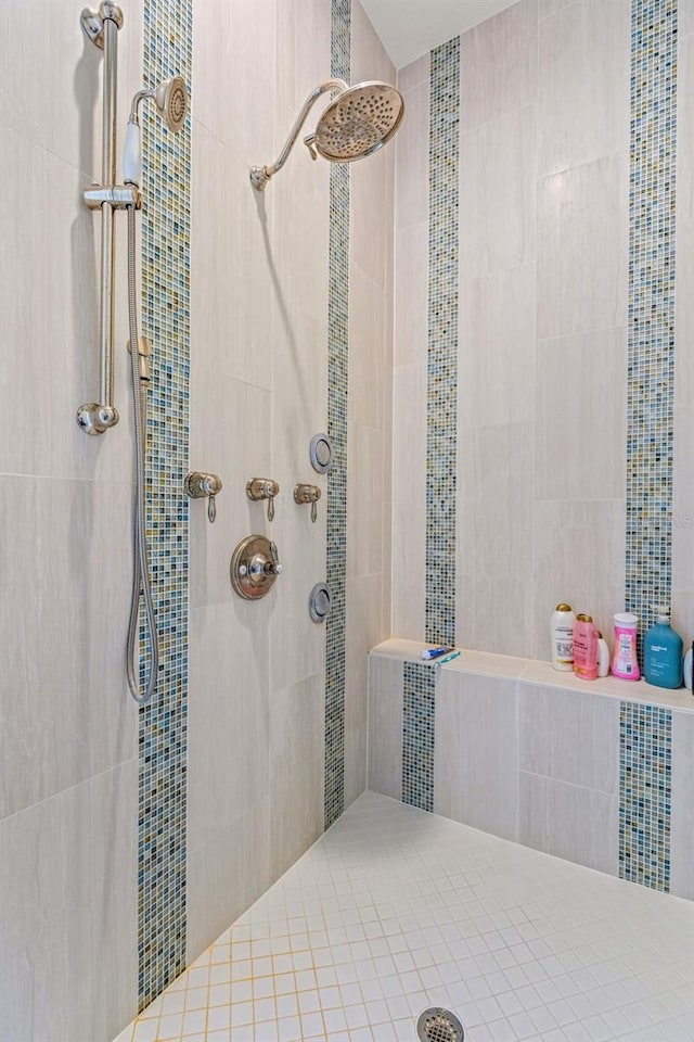 bathroom with a tile shower