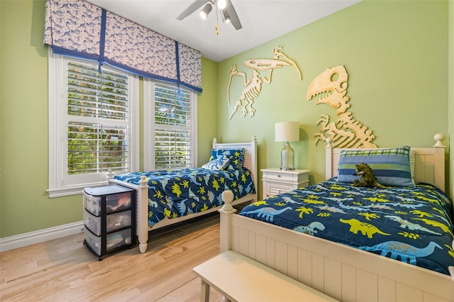 bedroom with ceiling fan and light wood-type flooring