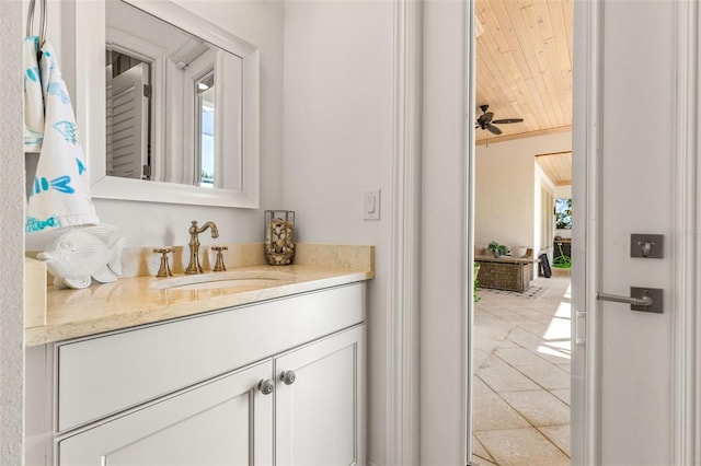 bathroom with crown molding, vanity, ceiling fan, and tile patterned flooring