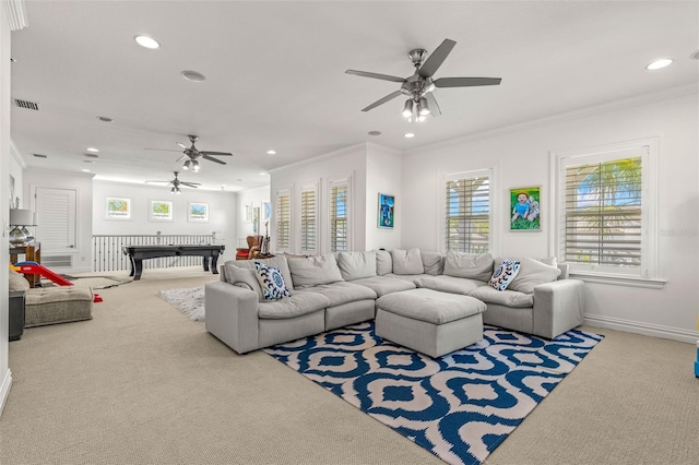 living room with ceiling fan, crown molding, and carpet floors