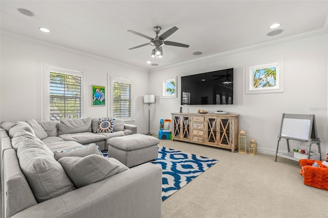 carpeted living room with ornamental molding and ceiling fan