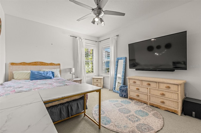 bedroom featuring light carpet and ceiling fan