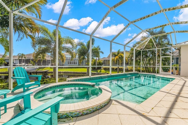 view of pool featuring a lanai and an in ground hot tub