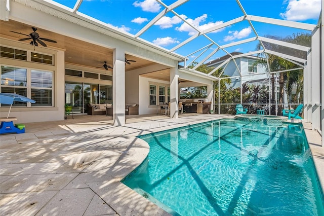 view of swimming pool featuring glass enclosure, ceiling fan, and a patio