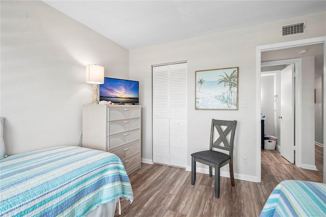 bedroom featuring light hardwood / wood-style floors and a closet