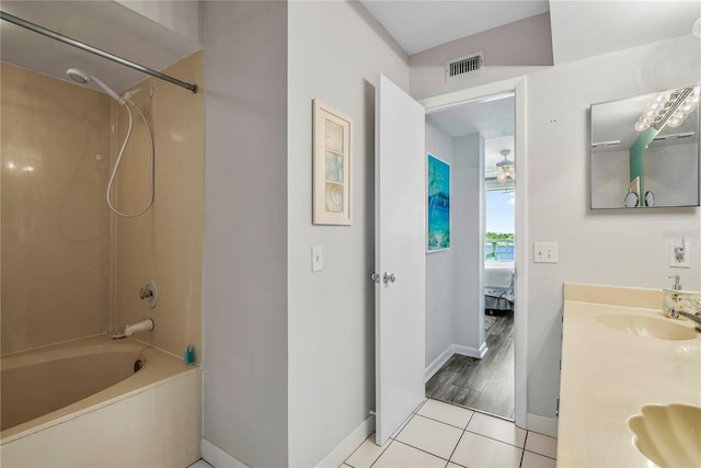 bathroom with tile patterned flooring, shower / washtub combination, and vanity