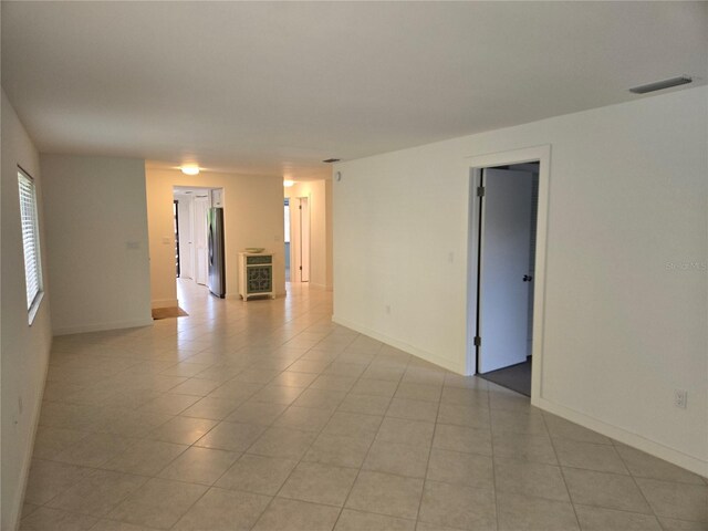 tiled spare room featuring wine cooler