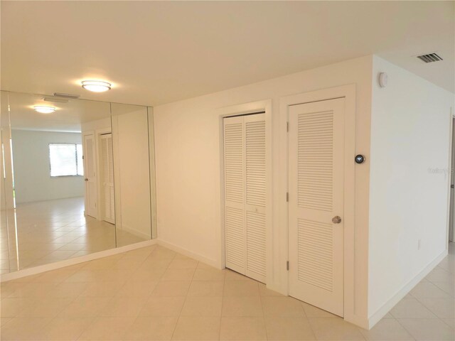 corridor with light tile patterned floors