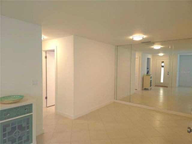 unfurnished room with light tile patterned floors