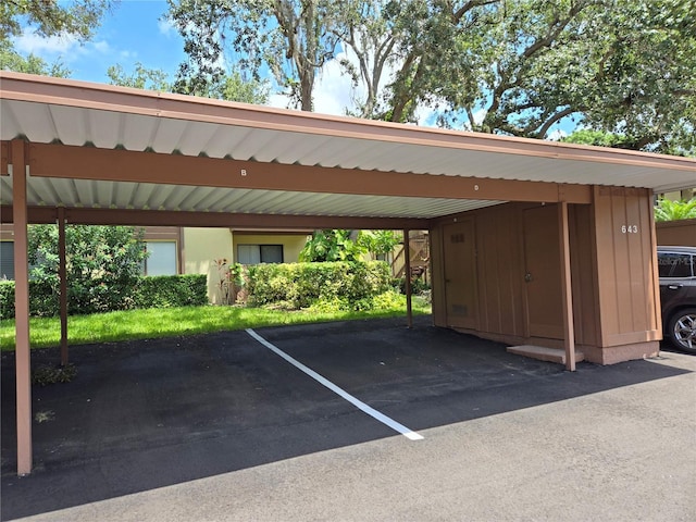 view of vehicle parking with a carport