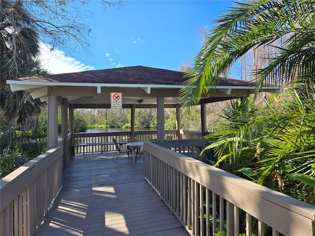 wooden deck featuring a gazebo and a water view