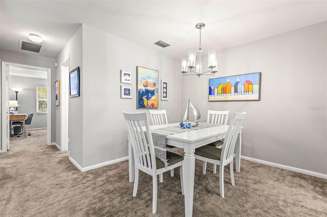 carpeted dining room with a notable chandelier and a textured ceiling