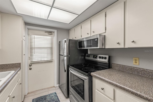 kitchen with white cabinetry and appliances with stainless steel finishes