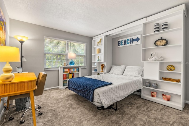 bedroom with carpet, baseboards, and a textured ceiling