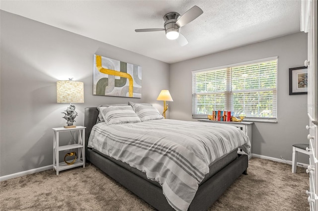 bedroom with ceiling fan, a textured ceiling, and carpet floors